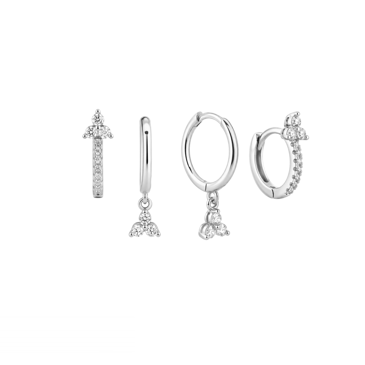 Four silver-toned huggie hoop earrings with clear crystal details, arranged on a plain white background.