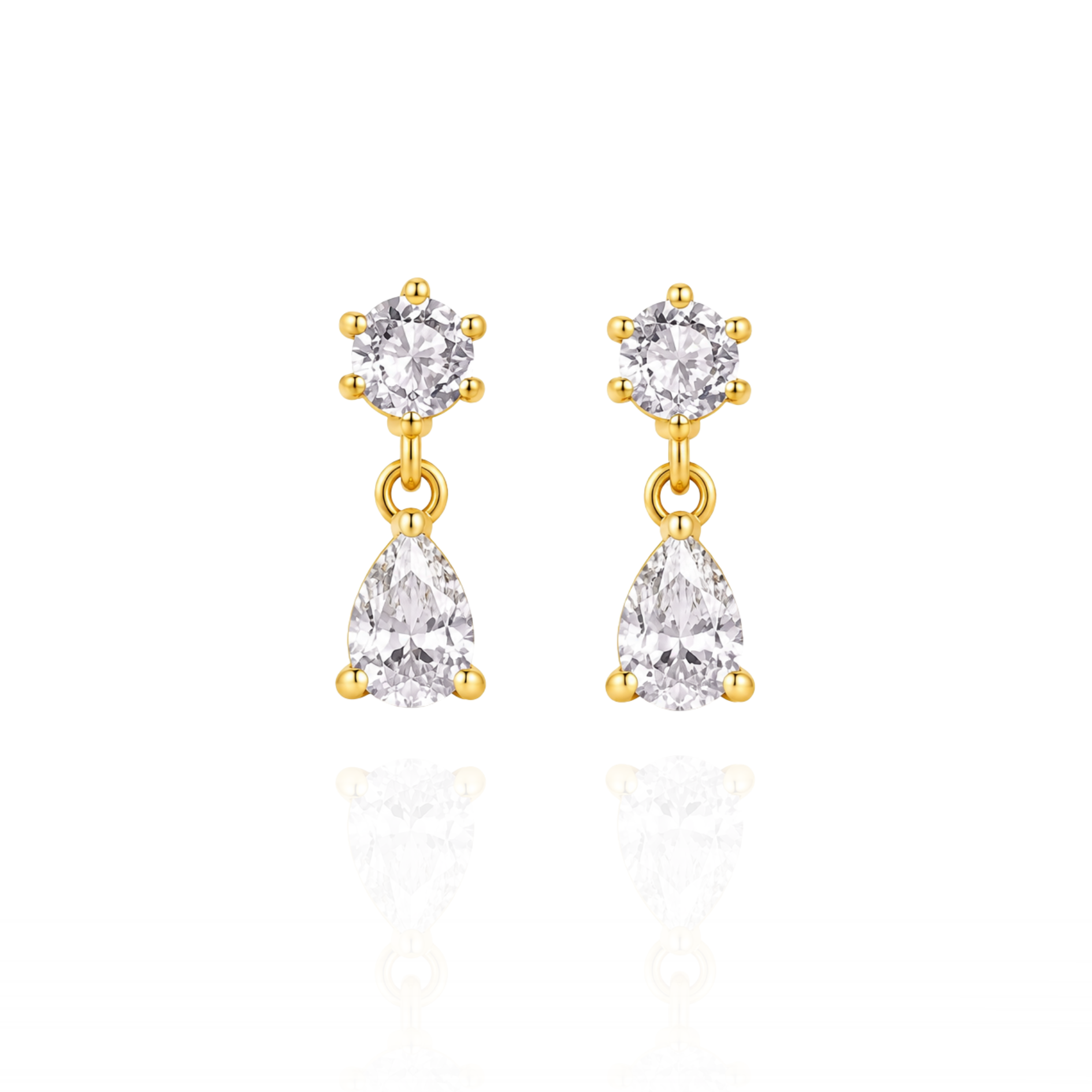 Gold earrings with clear gemstones on a white background
