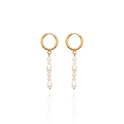 A pair of gold hoop drop earrings with dangling white pearl beads, shown on a clean white background with a soft reflection below.