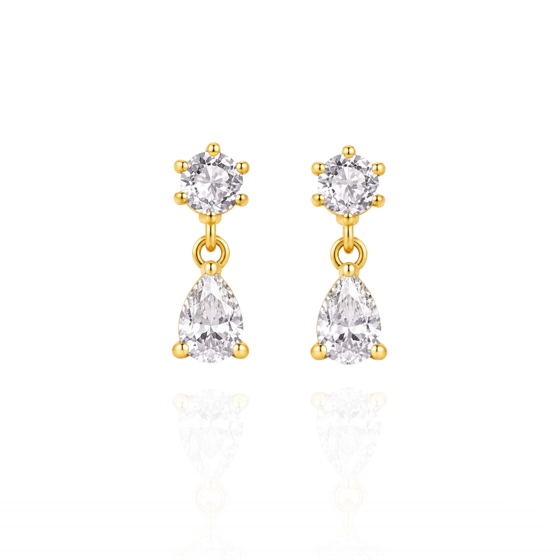 Gold earrings with clear gemstones on a white background