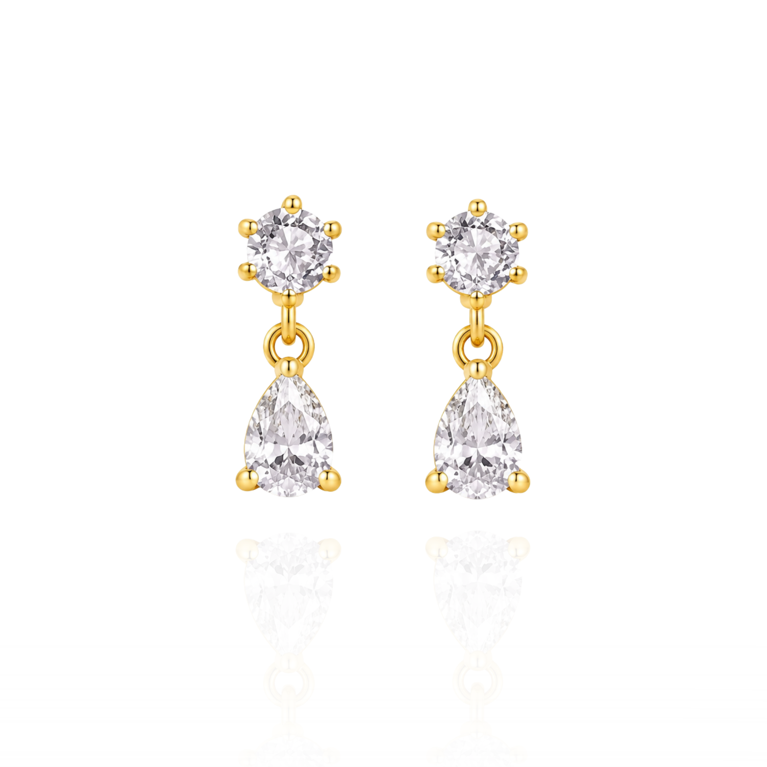 Gold earrings with clear gemstones on a white background