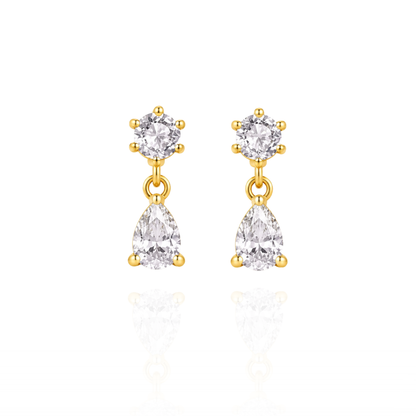 Gold earrings with clear gemstones on a white background